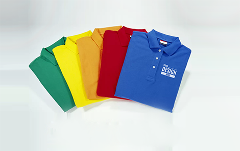 A group of different colored polo shirts on top of each other.